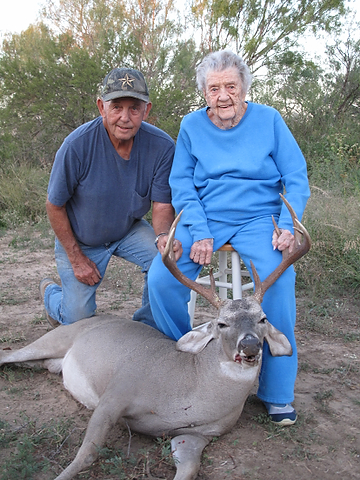 THIS YEAR'S BUCK: Mary and her son, George, show off this year's buck. Photo by Robert Hundley III. 100-yo2